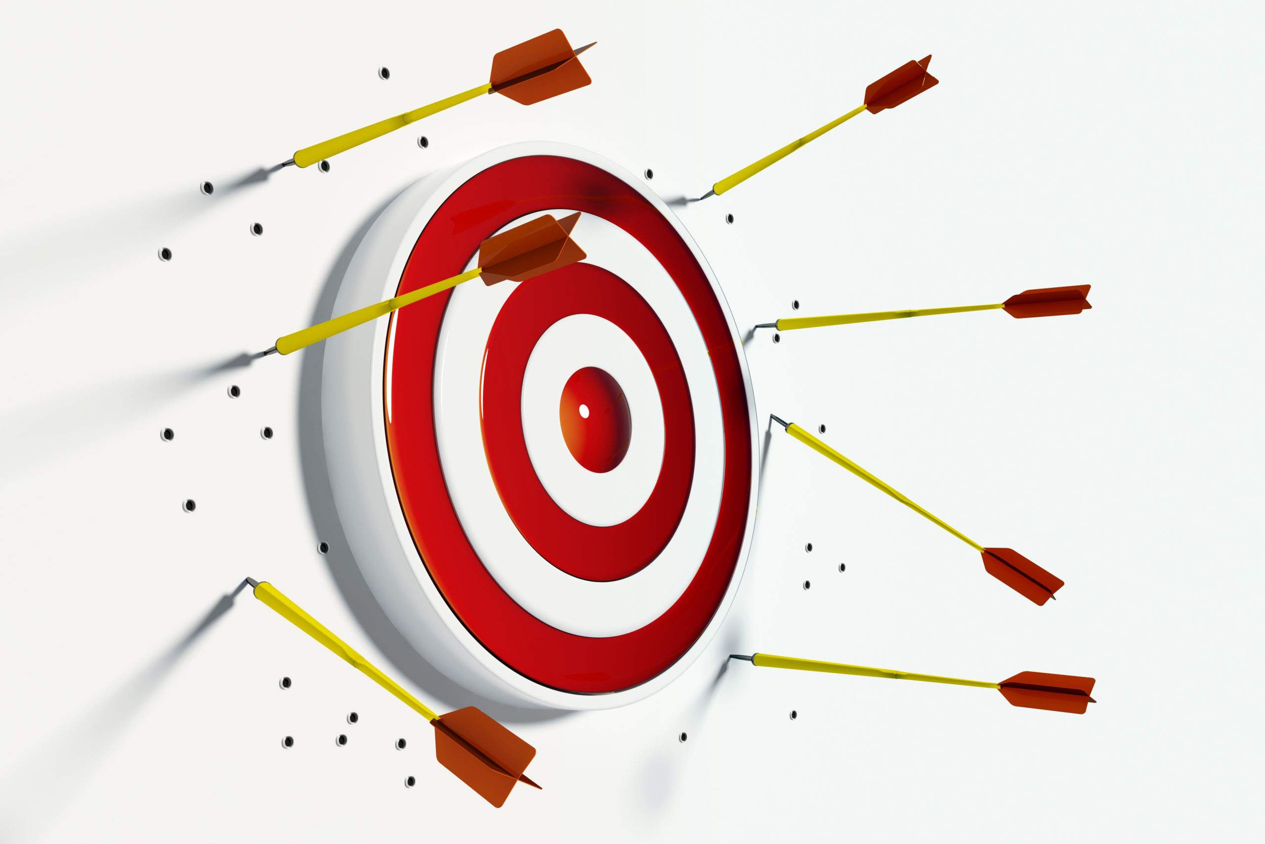 Multiple arrows hitting and missing a red and white target bullseye.