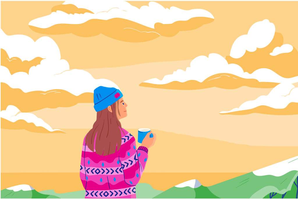 A woman doing a breathing meditation for anxiety overlooking mountains.