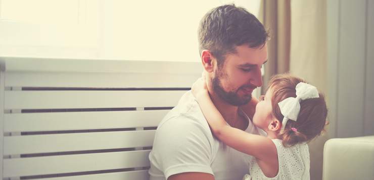father and daughter sitting together, smiling