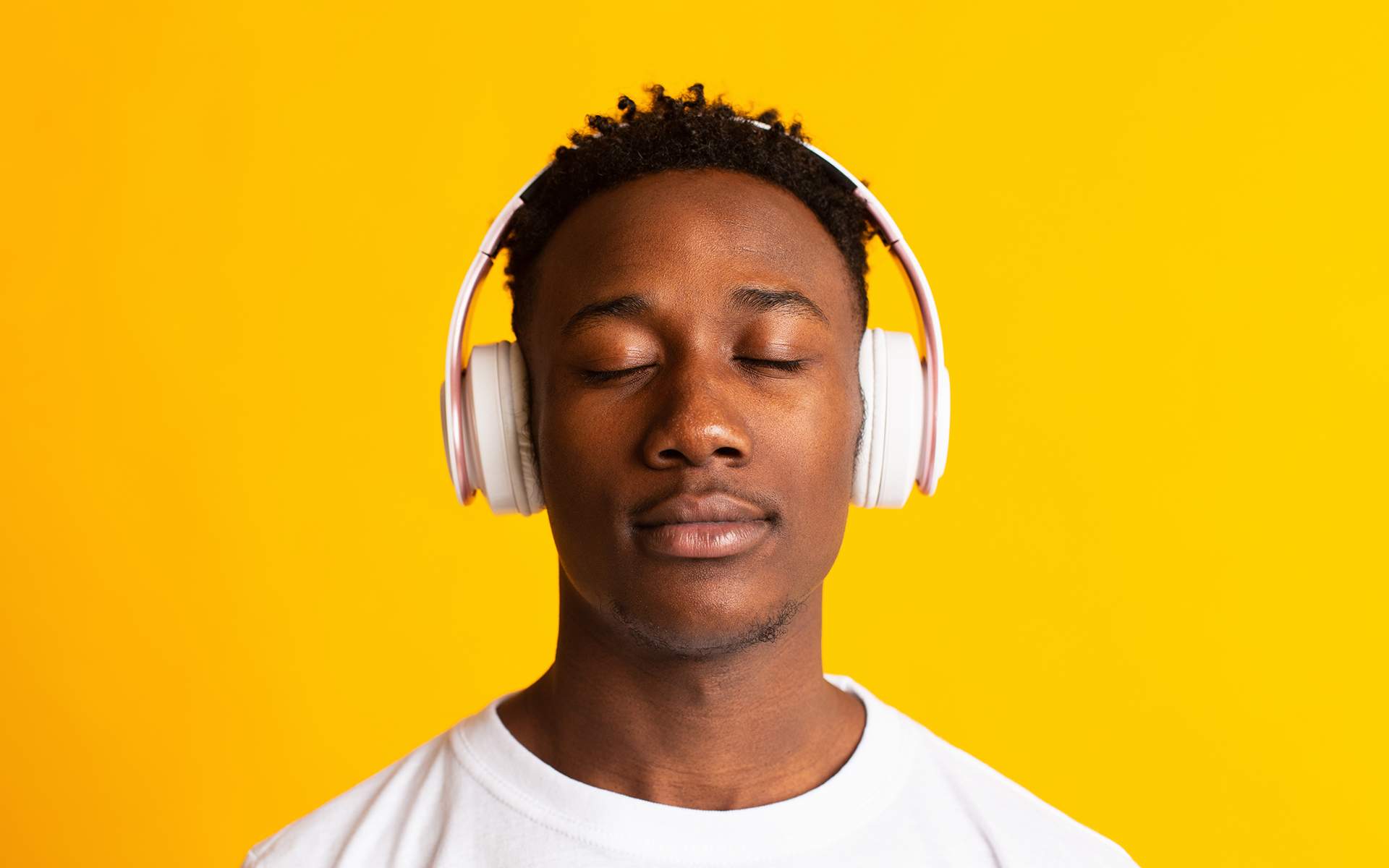 Guided Meditation for Focused Awareness - Man listening to music with headphones, closed eyes and relaxed