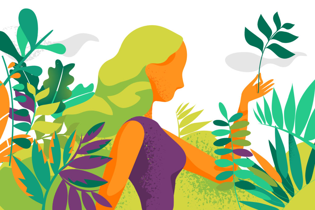 A woman surrounded by lush green plants and foliage.