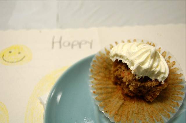 A blue plate with a cupcake on it.