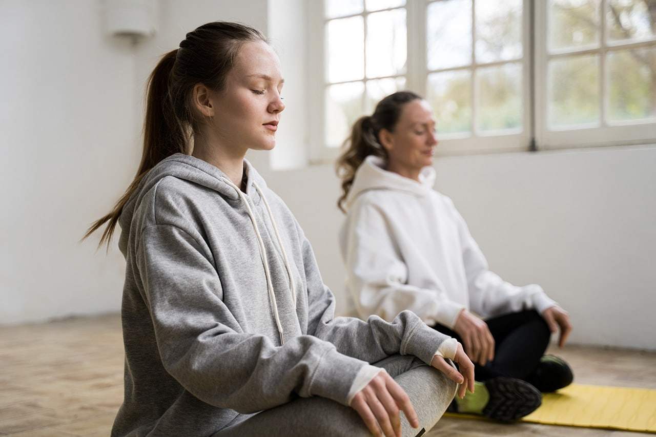 Teen and adult practice mindfulness meditation