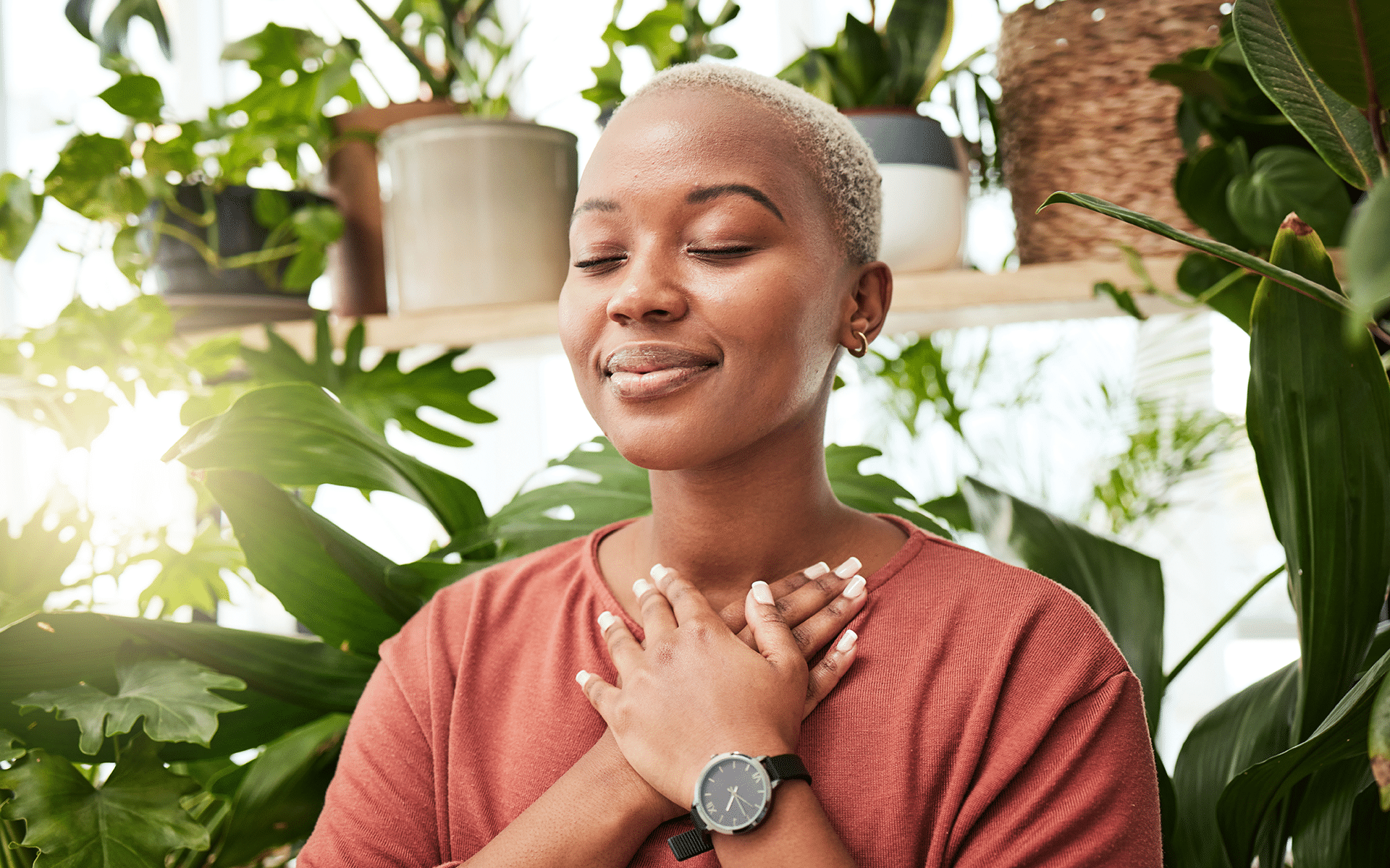 Woman with hands on heart, cultivating a sense of inner calm.