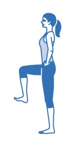 A woman performing a standing knee lift exercise.